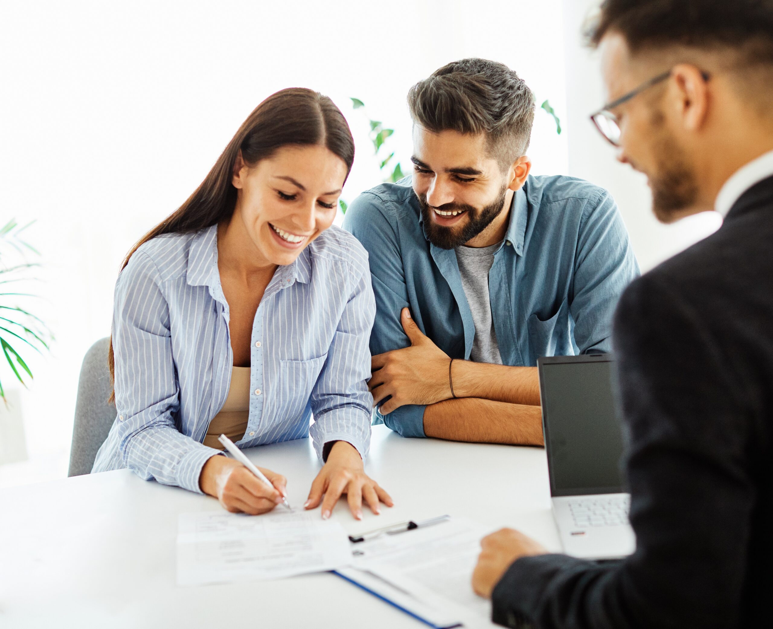 Couple happily signing documents