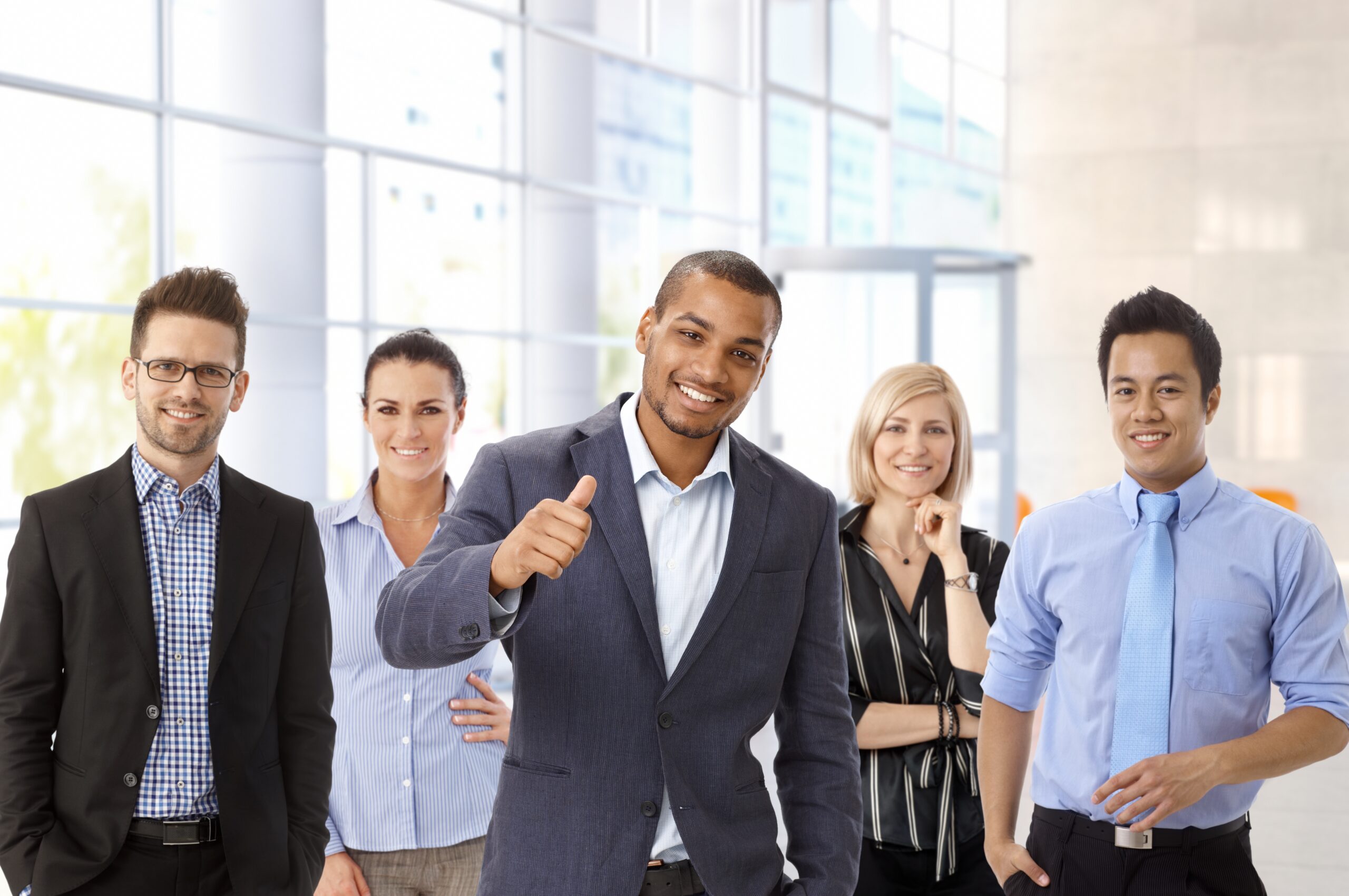 A diverse group of five professionals poses confidently